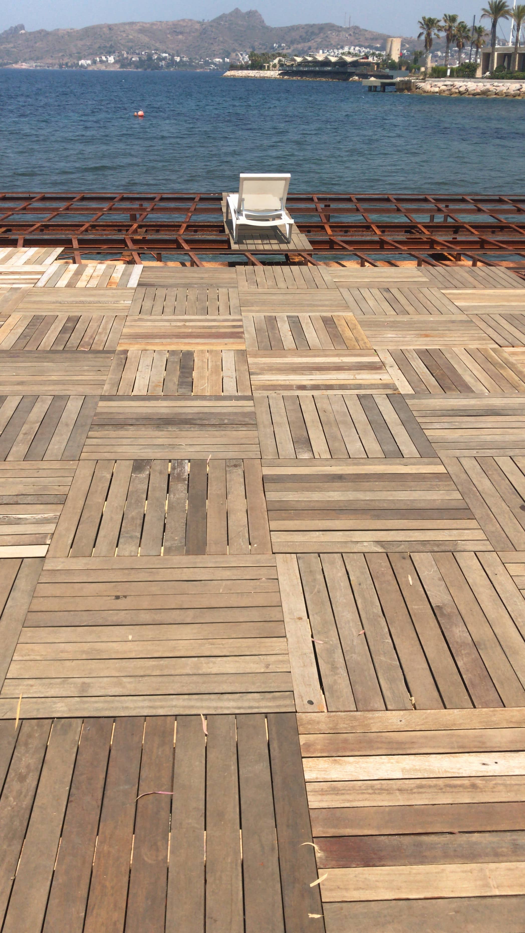 Near complete beach club deck. Repurposed old decking to create new, durable design of deck tiles. Ugur Bolat designed, project managed and oversaw team to install entire deck